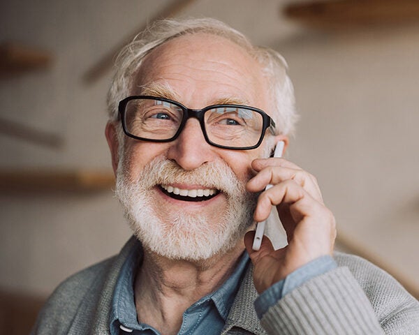 happy bearded senior man talking by phone