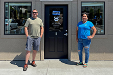 Artists Mary and Rob post in front of their studio