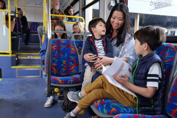 Asian young family ride the bus together